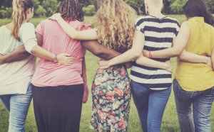 A group of women put their arms around each other during their womens rehab program that is part of the rehab Asheville NC offers