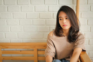 A woman looks serious as she thinks about narrowing down the top residential eating disorder treatment centers