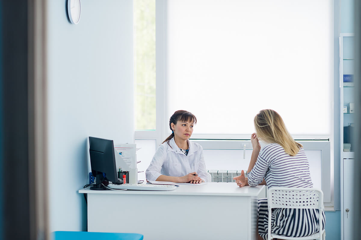 friendly female doctor comforting middle aged patient in hospital addiction treatment professional explains options for addiction help for women in california